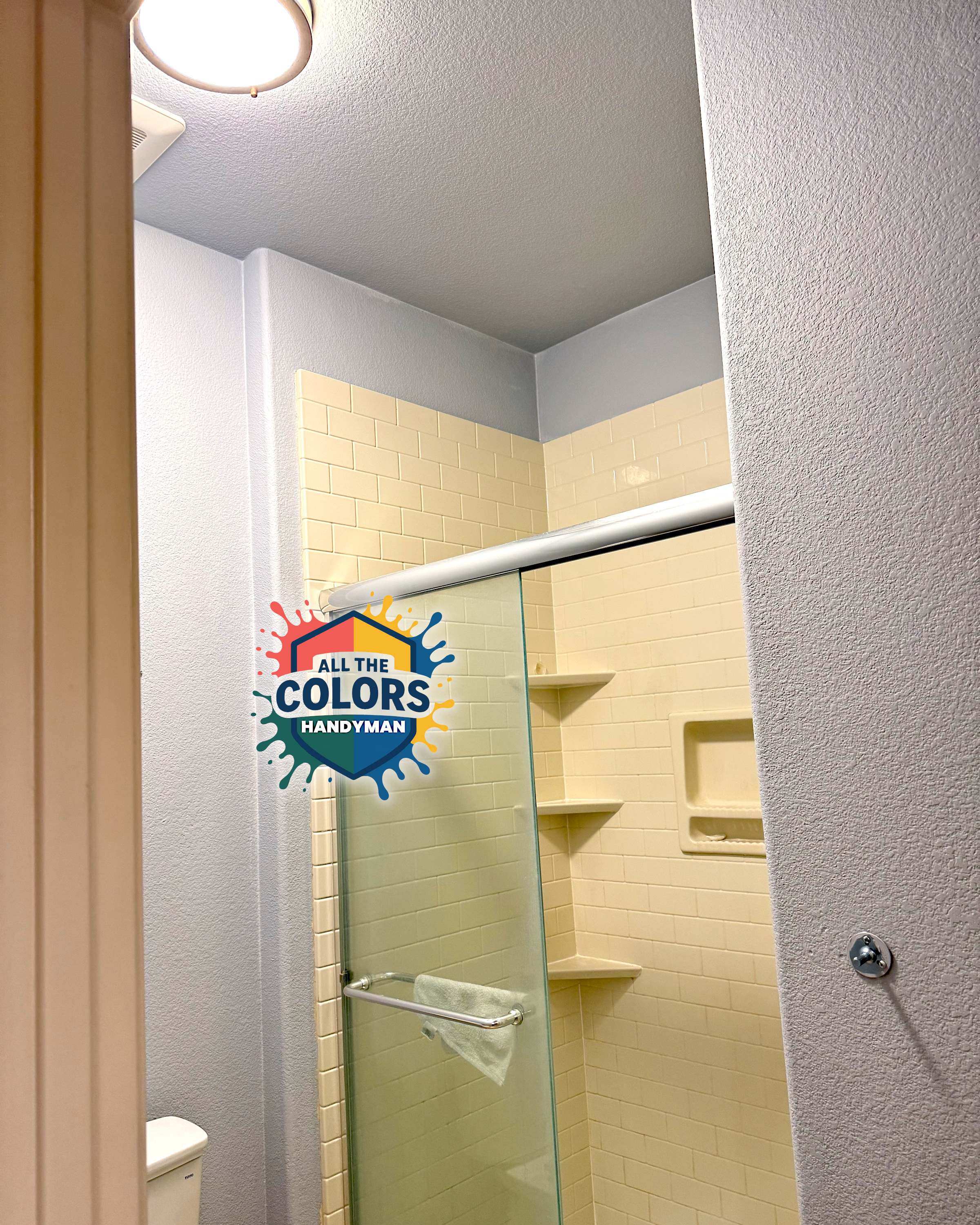 A screened porch from the outside. The oversize window is covered with sturdy screen material in black. The edges are neat and the spline is also black.